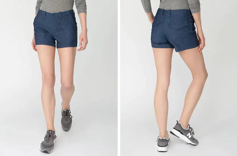 Waist down view of a model wearing the DU/ER Weightless Denim Adventure Short in dark blue