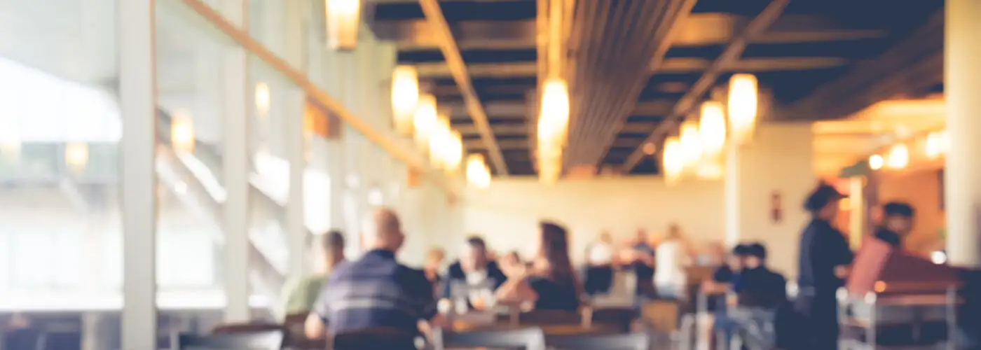 Blurry image of a softly lit airport cafe