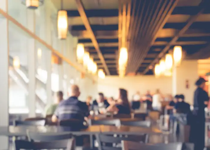 Blurry image of a softly lit airport cafe