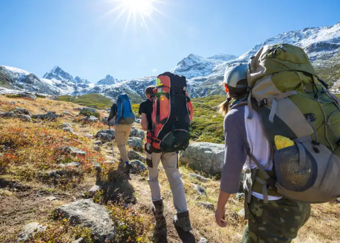 Hikers backpacking towards distant mountains