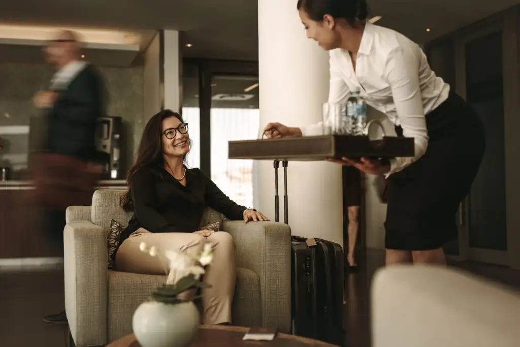 Person serving a business traveler sitting in the airport lounge