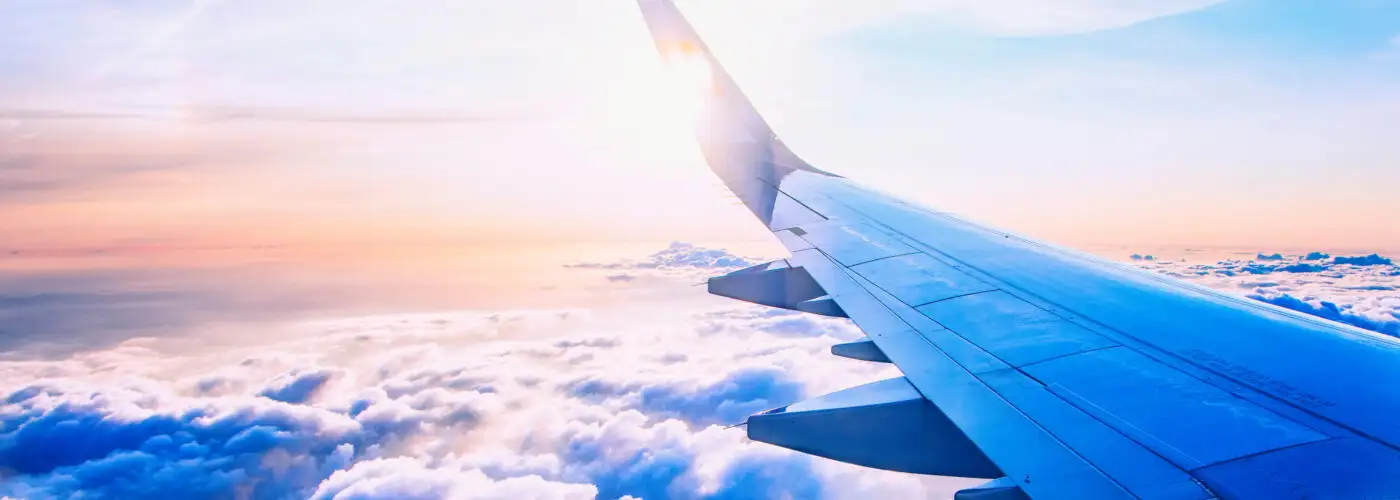 Airplane wing as seen from airplane window mid-flight