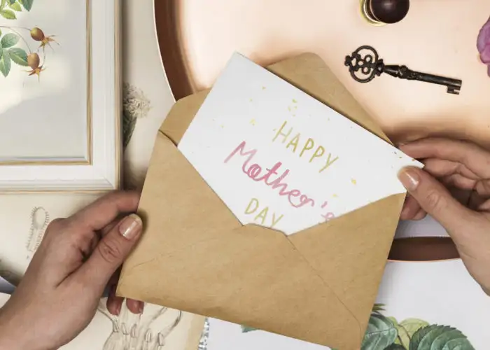 Hands opening a Mother's Day card