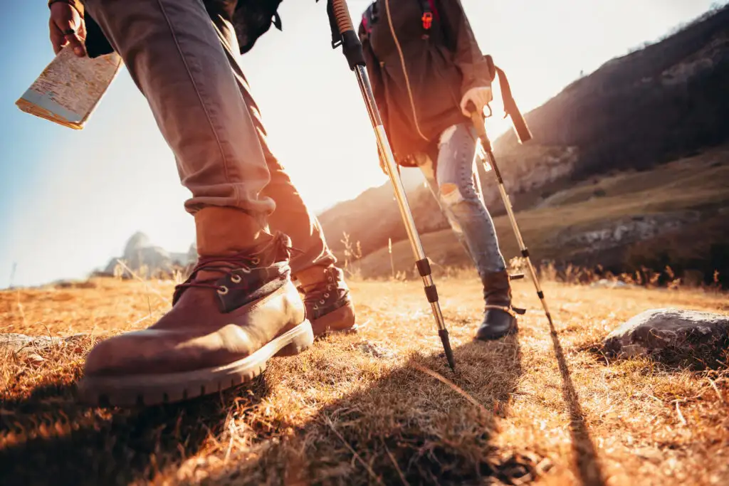 Close up of two hikers' feet climbing up a trail, wearing hiking boots