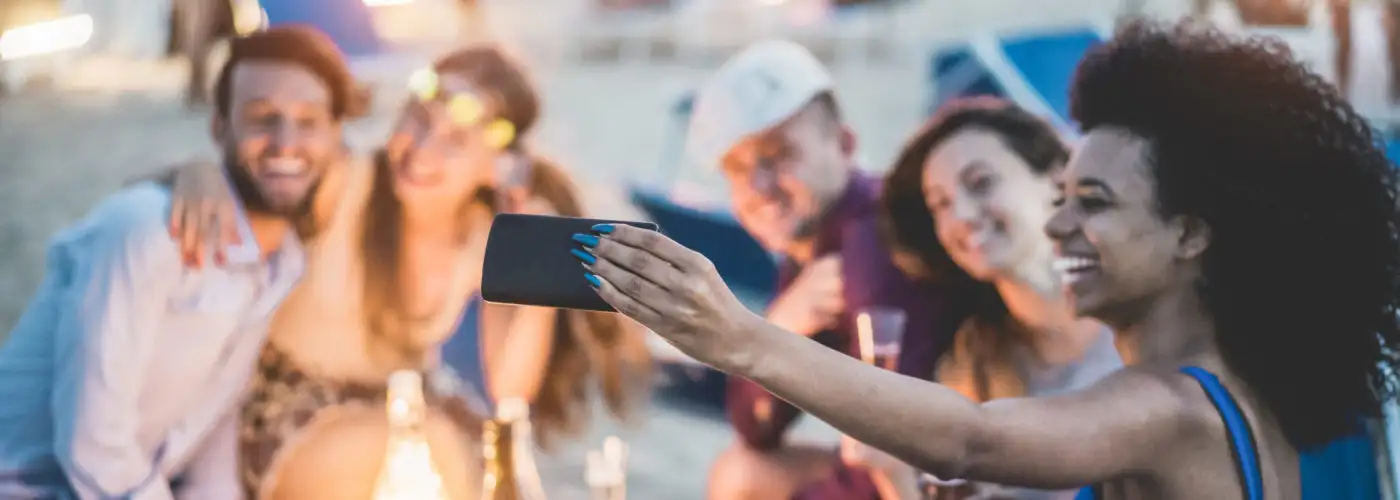 Friend taking selfies at the beach