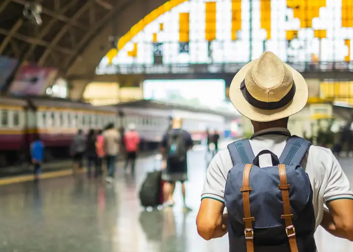 Man with backpack in train station