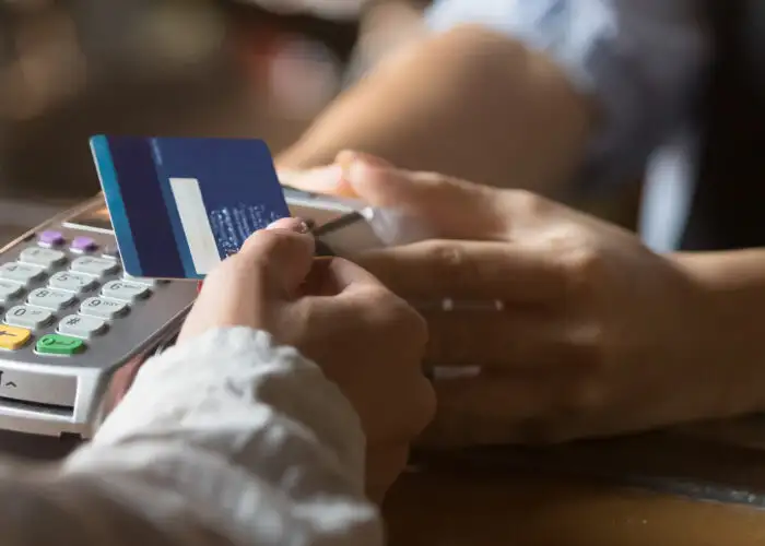 Close up of person scanning a blue credit card