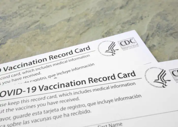 Two COVID-19 vaccination cards