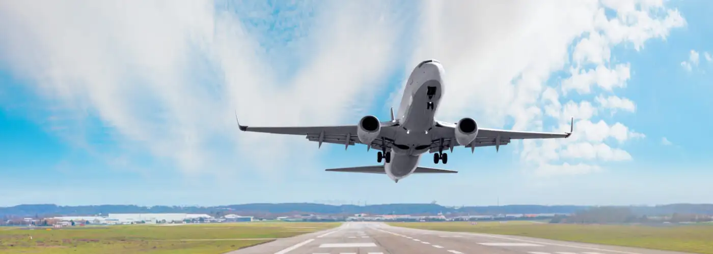 Passenger plane taking off runway on a clear day