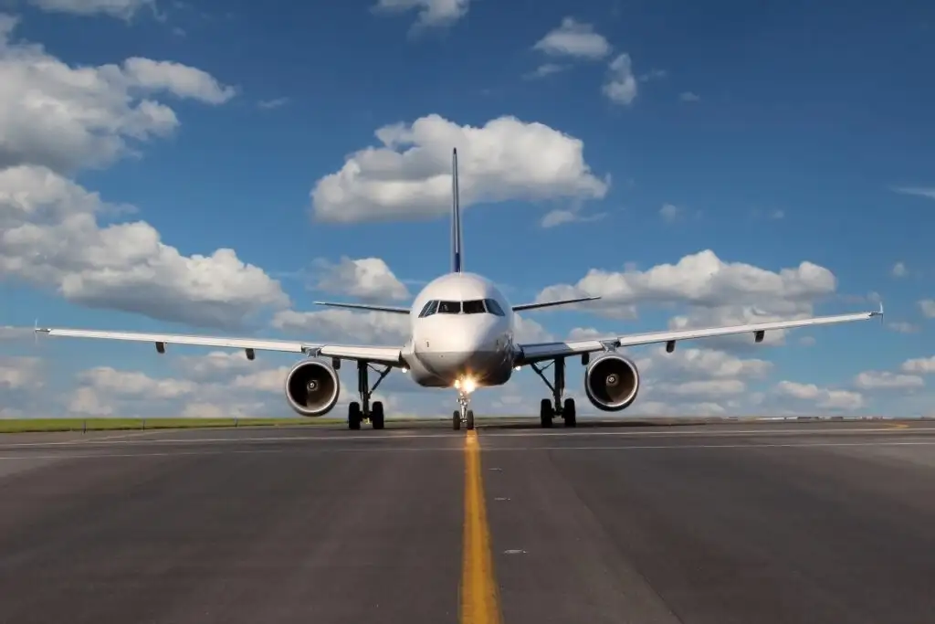 Airplane taking off on runway on a clear day