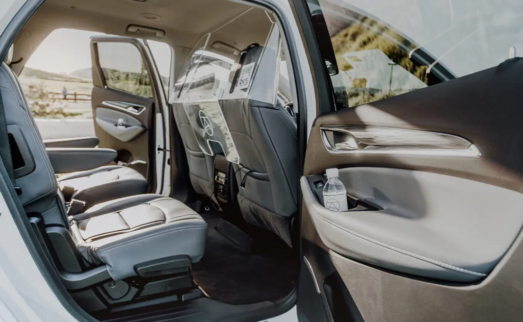 Inside Alto ride share vehicle rear with front sanitary divider