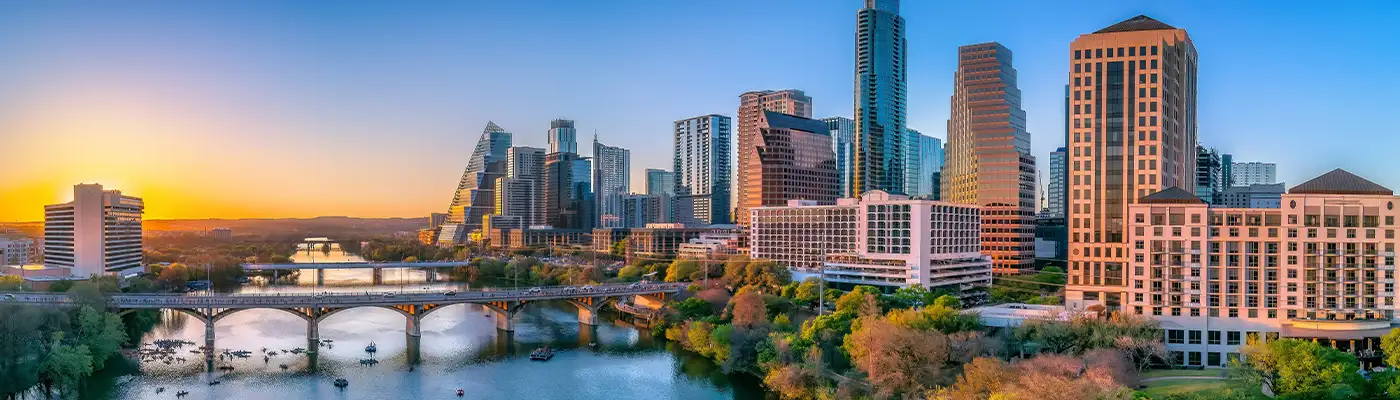 Austin, Texas- Panoramic cityscape and Colorado River against the sunset sky