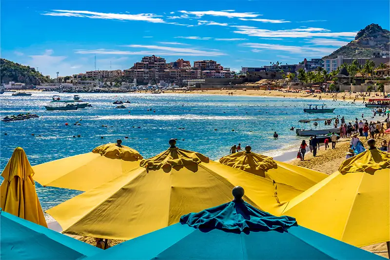 Busy beach in Cabo San Lucas, Mexico on a sunny day