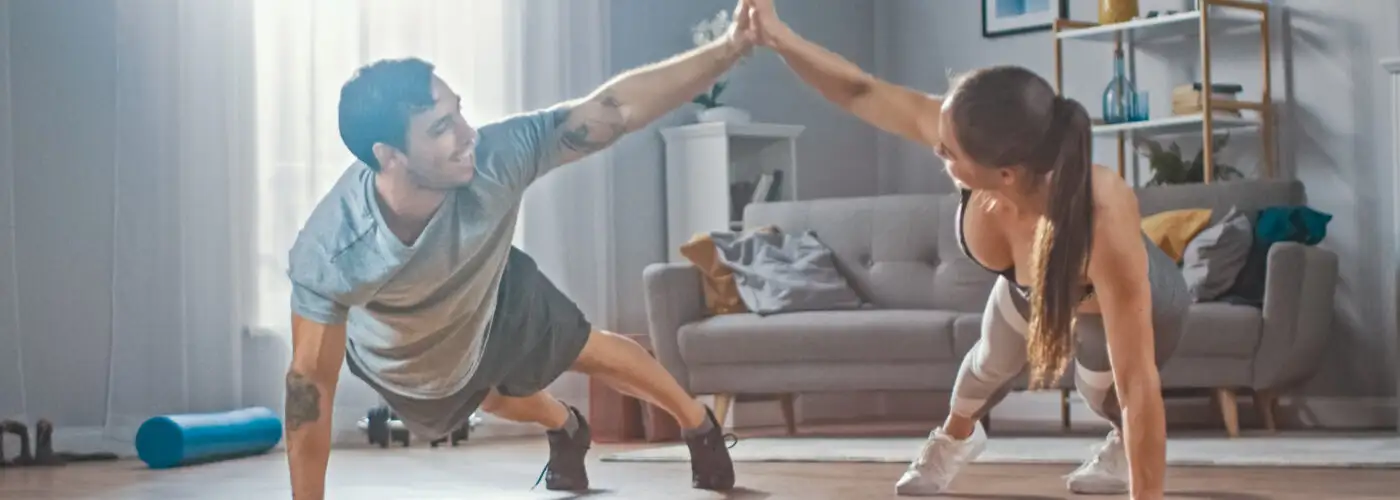 Couple working out in home gym