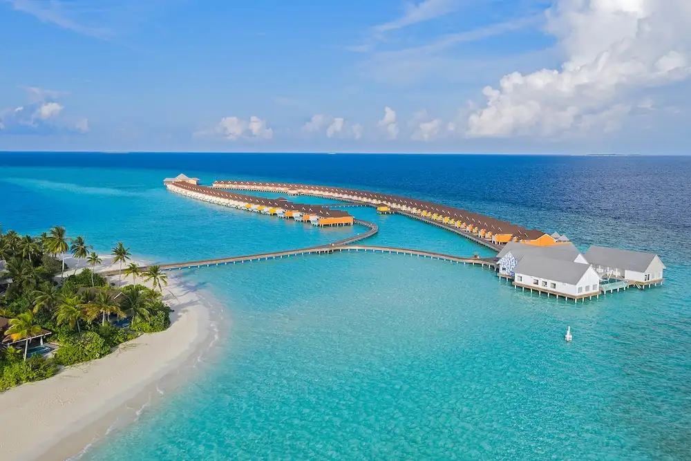 Aerial view of overwater bungalows at The Standard Huruvalhi Maldives