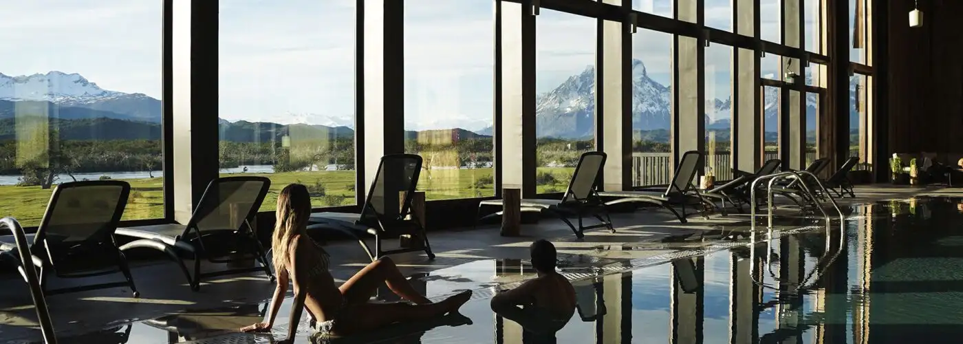 Two people relaxing in the pool at the spa at Rio Serrano Hotel & Spa