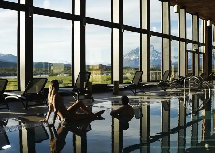 Two people relaxing in the pool at the spa at Rio Serrano Hotel & Spa