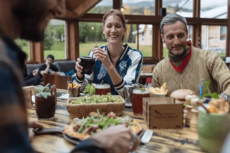 Two people laughing at the dinner table at Las Torres Patagonia Hotel