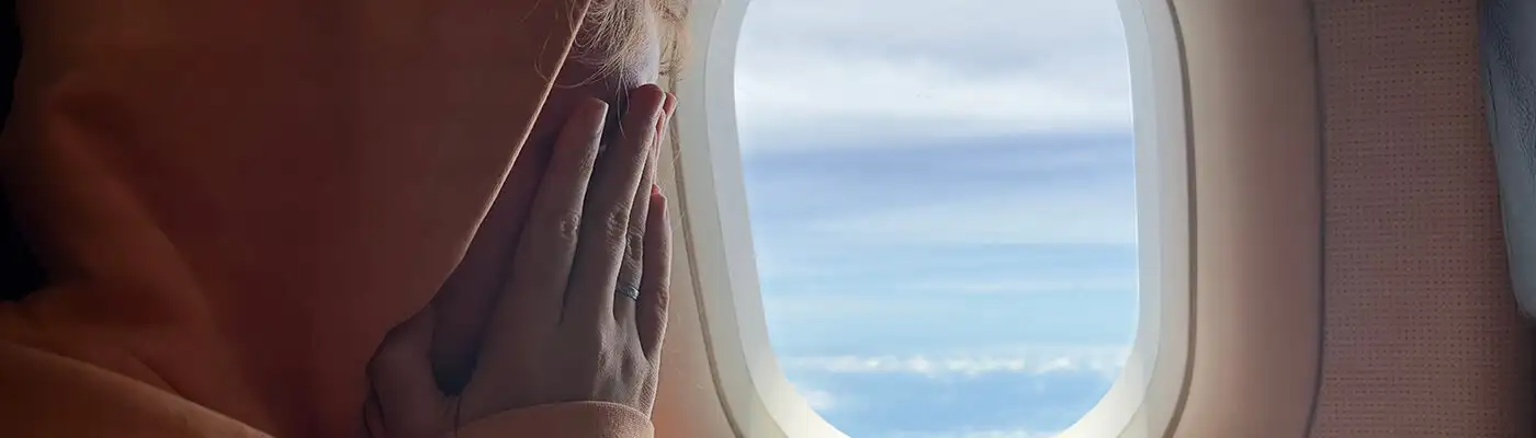 Close up of nervous woman on airplane