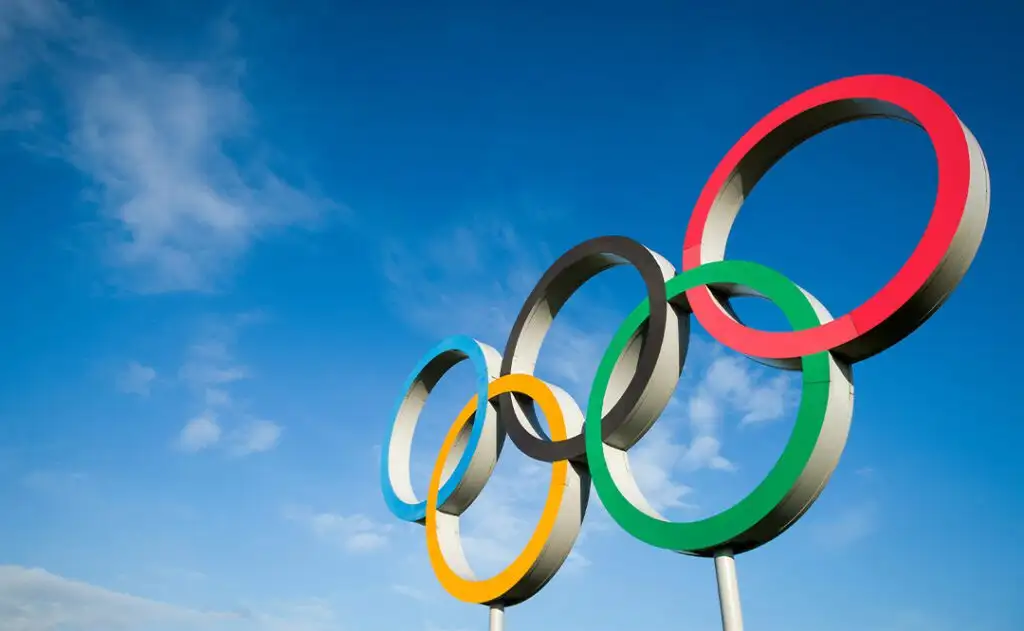 RIO DE JANEIRO - MARCH 18, 2016: A large set of Olympic rings shines in bright sunlight against blue sky.