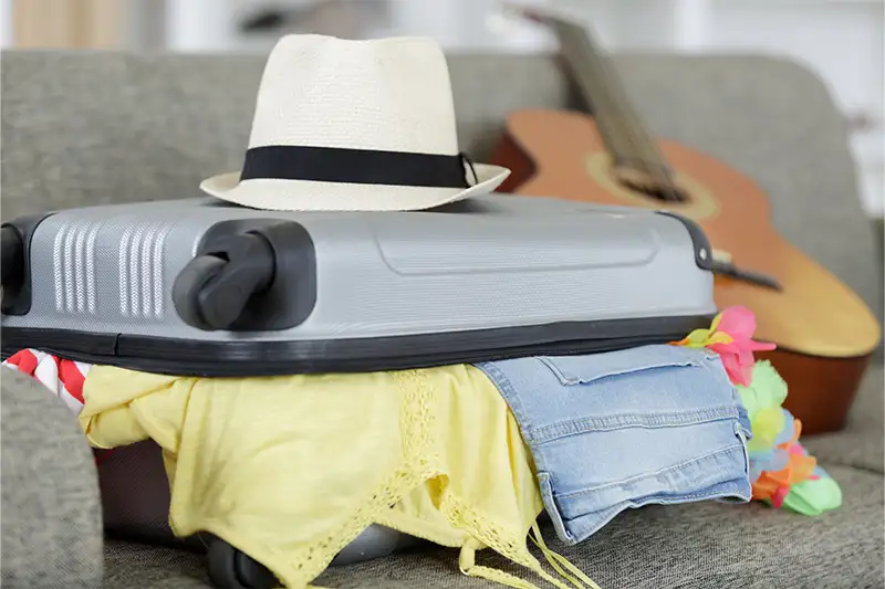 Overflowing suitcase on a couch