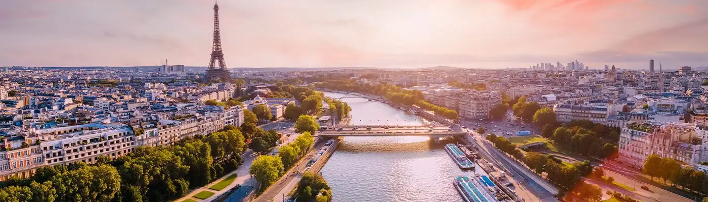 Paris aerial panorama with river Seine and Eiffel tower, France. Romantic summer holidays vacation destination. Panoramic view above historical Parisian buildings and landmarks with sunset sky