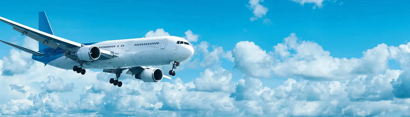 Jet plane in a blue cloudy sky