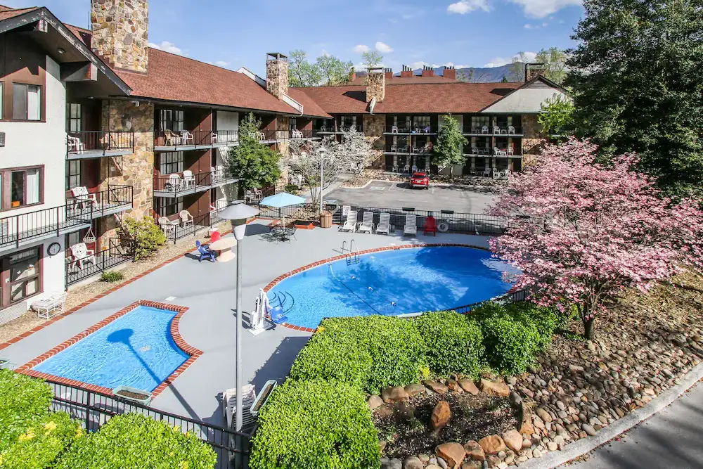 Exterior of the River Edge Inn showing outdoor pools.