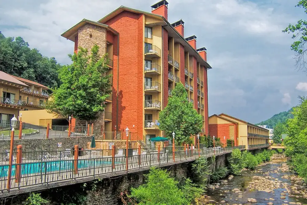 Exterior of The River Terrace Resort & Convention Center looking at the pool and river.