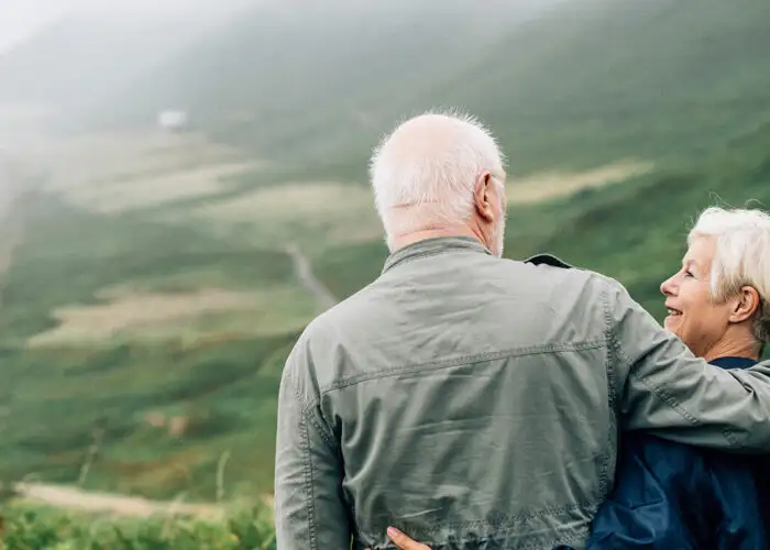 Happy senior couple enjoying a breathtaking view on vacation