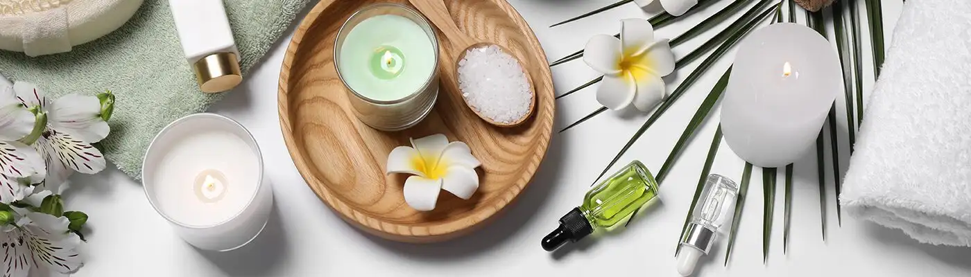 Table laid out with candles, flowers, and other wellness accessories, as seen from above