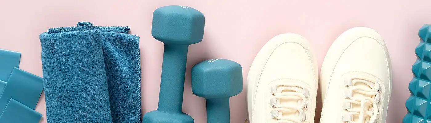 Fitness gear laid out on pink background