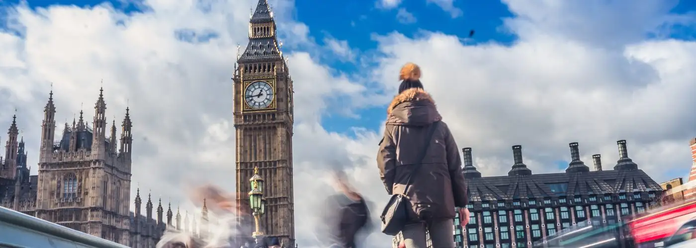 woman walking towards big ben in london