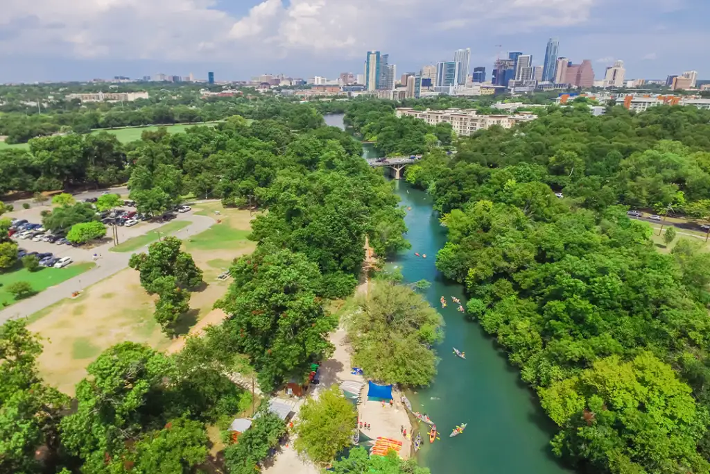 Aerial view Downtown from Barton Creek in Greenbelt at Zilker Metropolitan Park south Austin with summer blue cloud sky. Located at eastern edge of Hill Country, Austin the state capital of Texas, US.